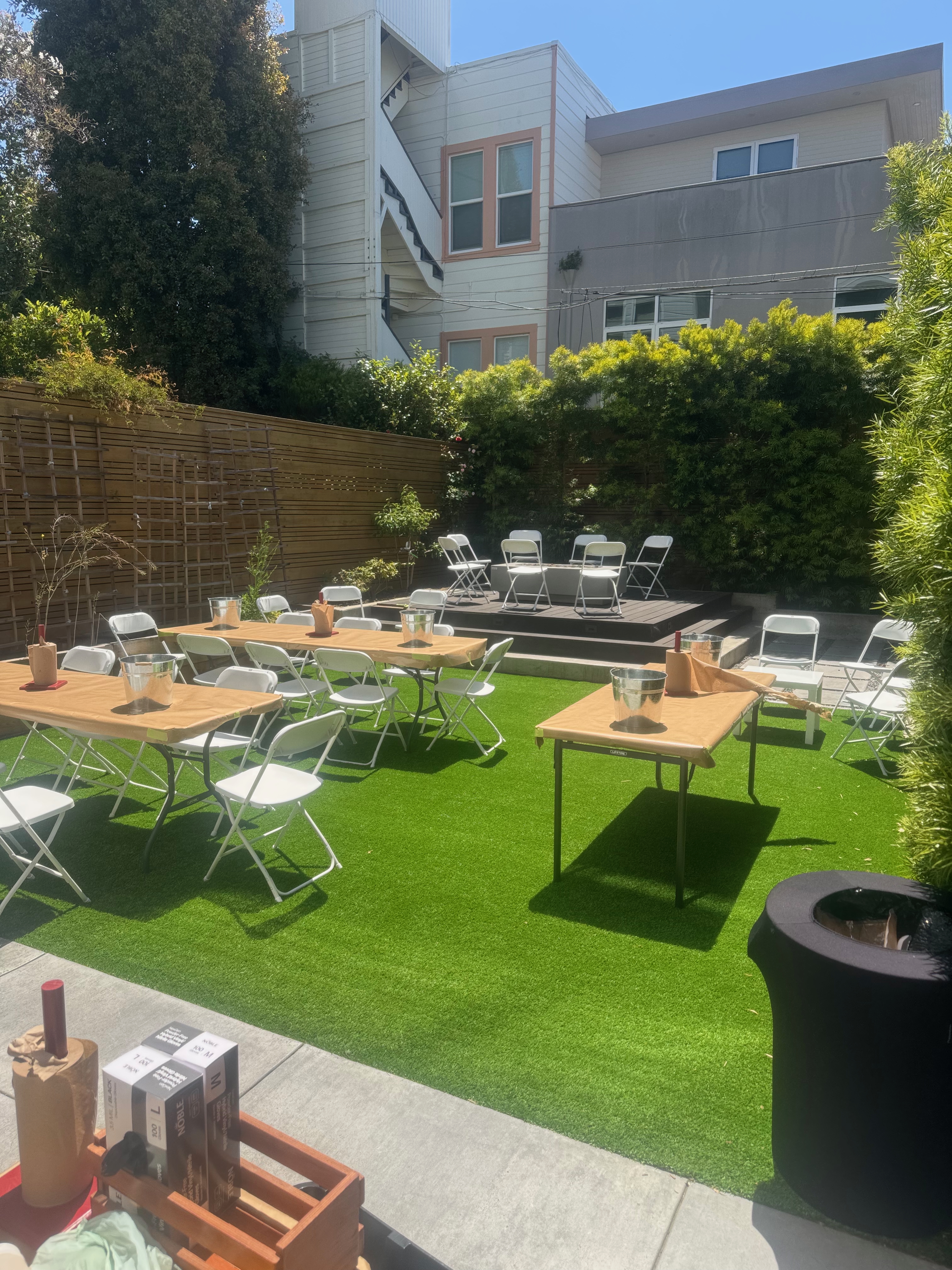 Private event venue setup with communal tables and stage